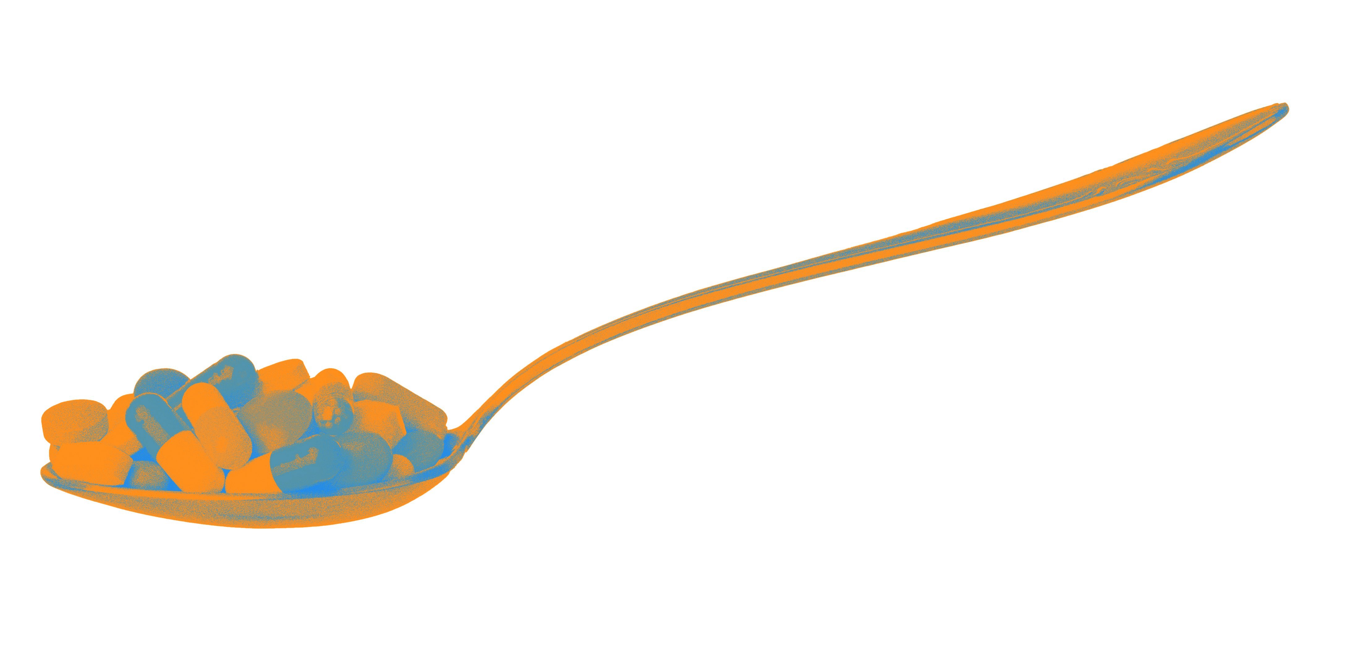 Spoon with pills and capsules