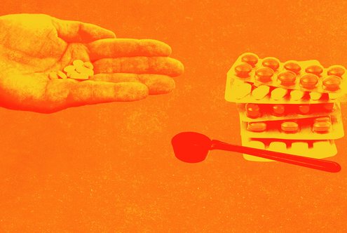 One hand holds pills, next to it tablet blisters and a dosing spoon