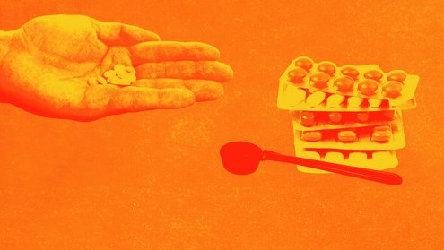 Eine Hand hält Pillen, daneben Tabletten-Blister und ein Dosierlöffel