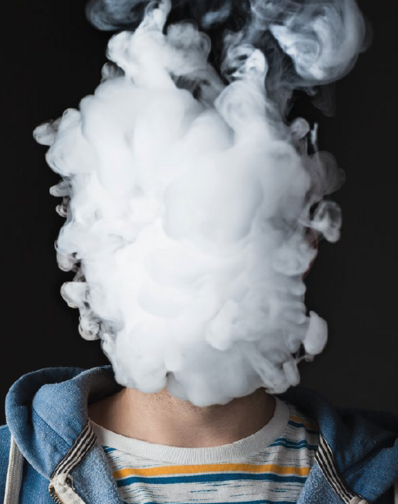 A person whose head is covered in vapour and whose face is therefore unrecognisable